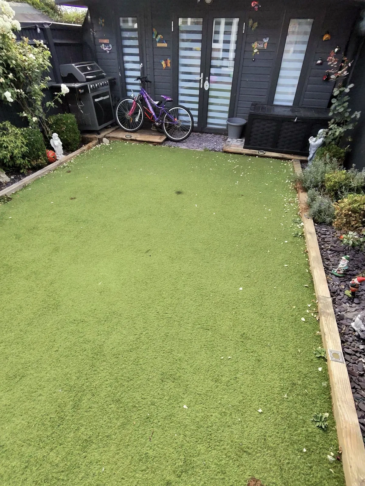 Artificial grass before cleaning showing matted fibres and debris