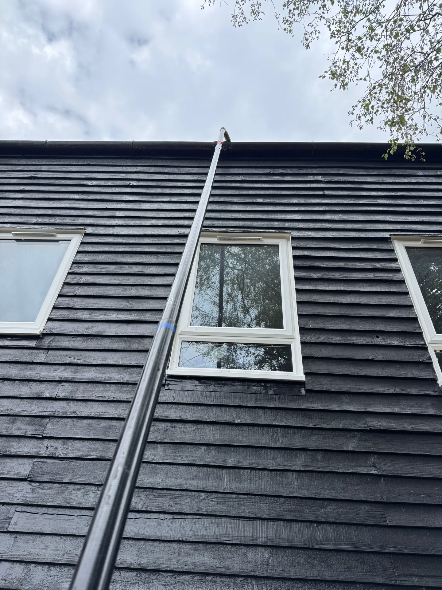 PowerJ using a reach pole for gutter cleaning at a property in Northcott, Bracknell