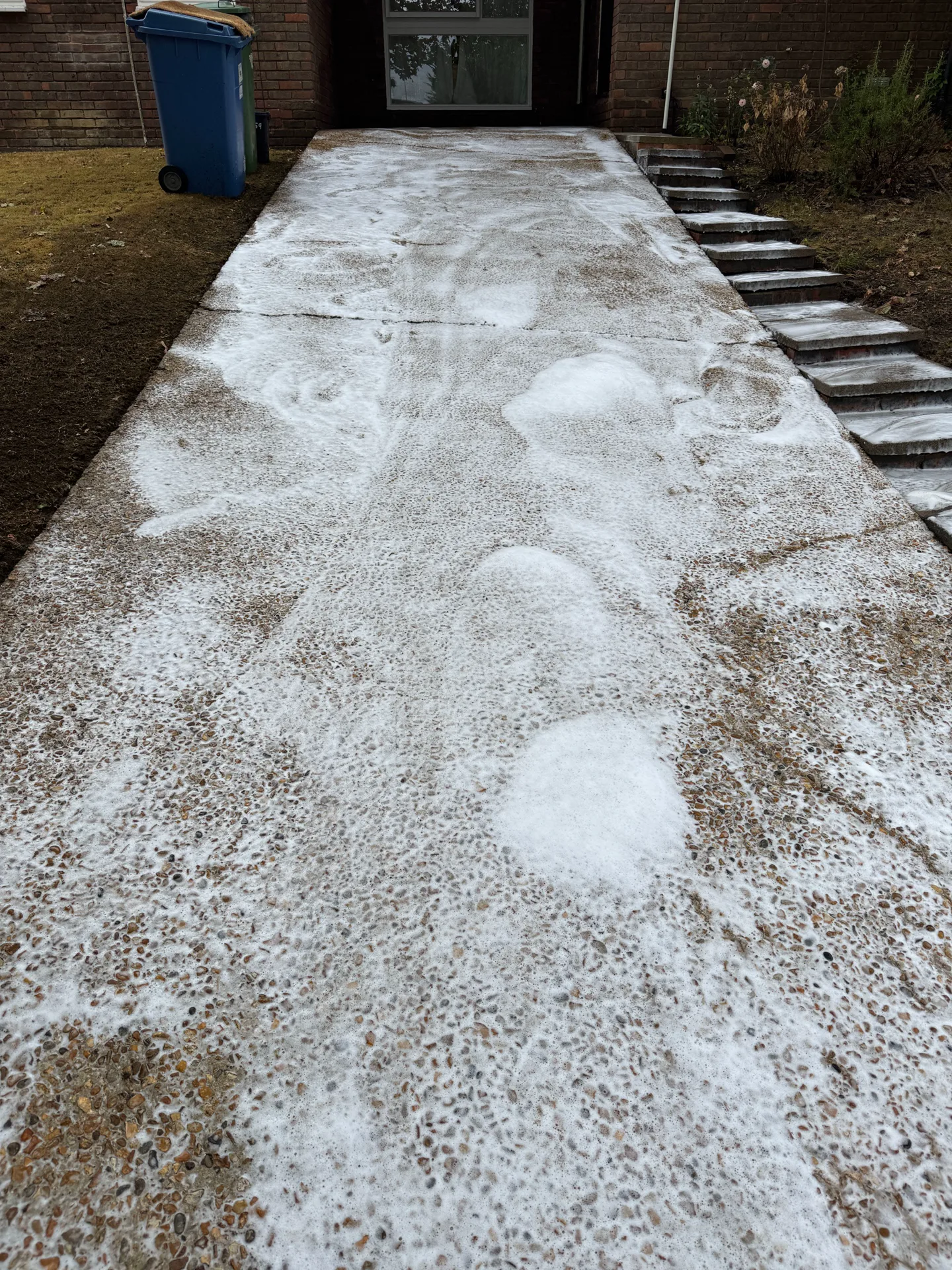 Post-clean hypo treatment being applied to a patio at a Northcott, Bracknell property