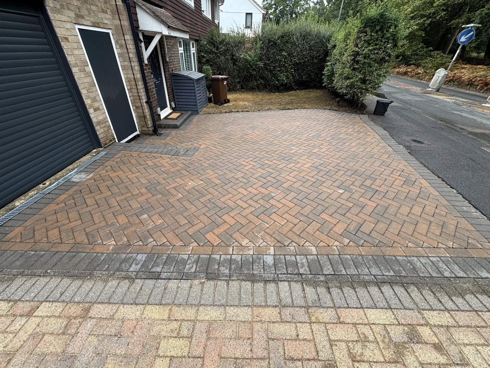 Restored red and grey block-paving driveway after PowerJ cleaning in Winkfield