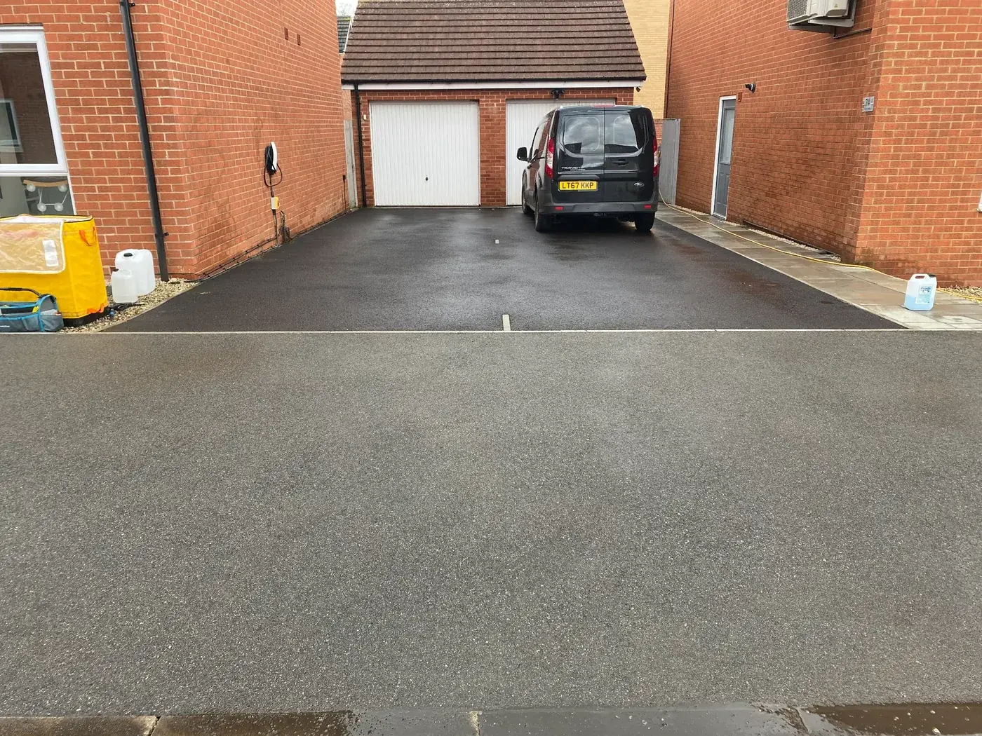 Freshly sealed tarmac driveway — PowerJ Exterior Cleaning driveway sealing result in Berkshire