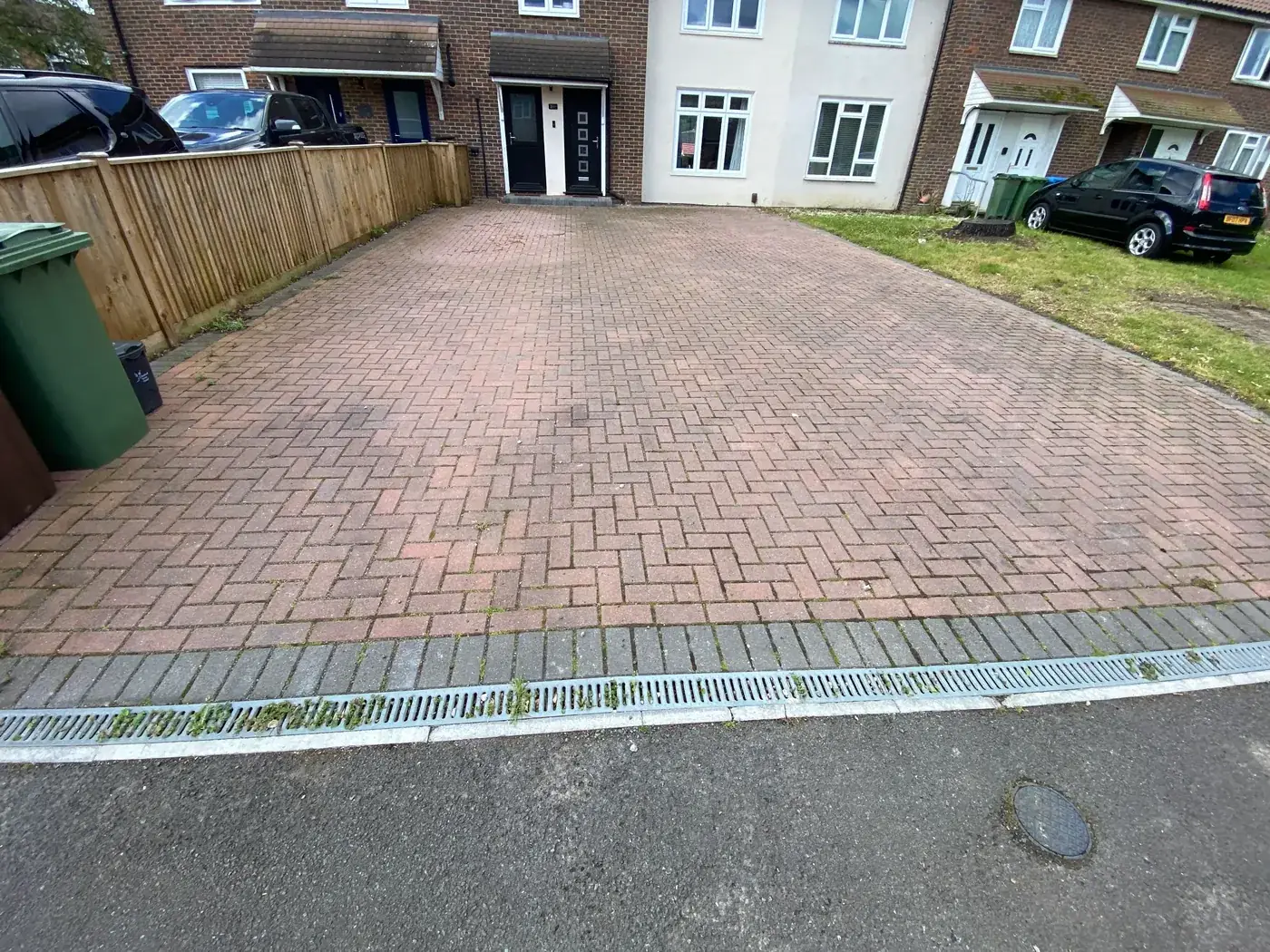 Block paving driveway before cleaning — dirty and mossy