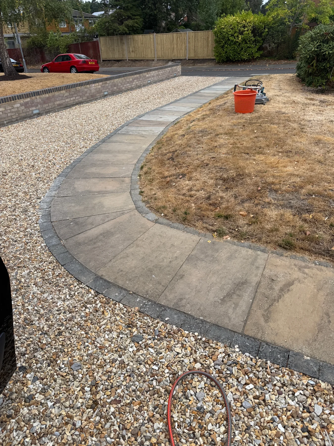 Curved stone patio path in Winkfield Row before cleaning