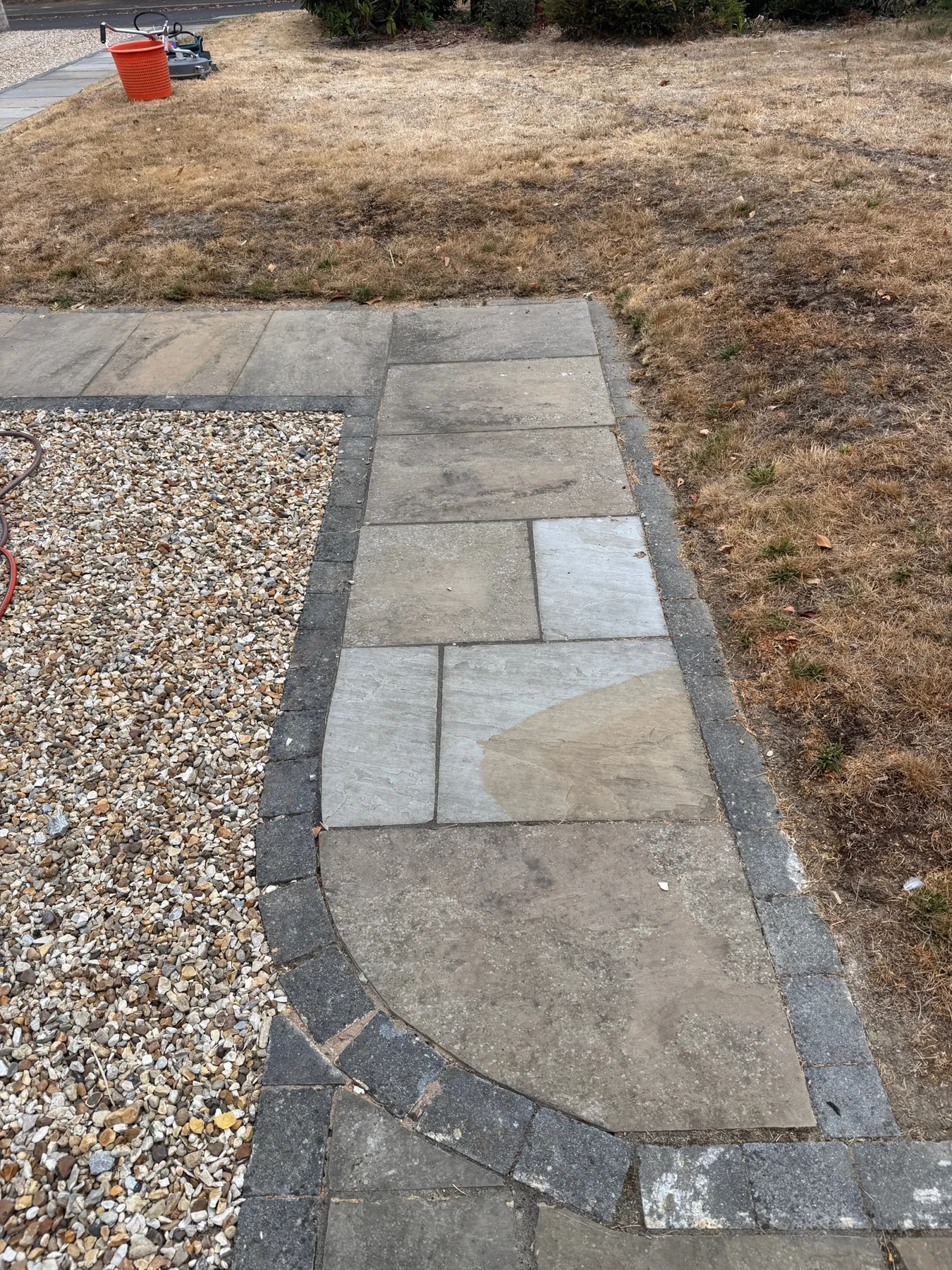 Stone patio path in Winkfield Row before pressure washing