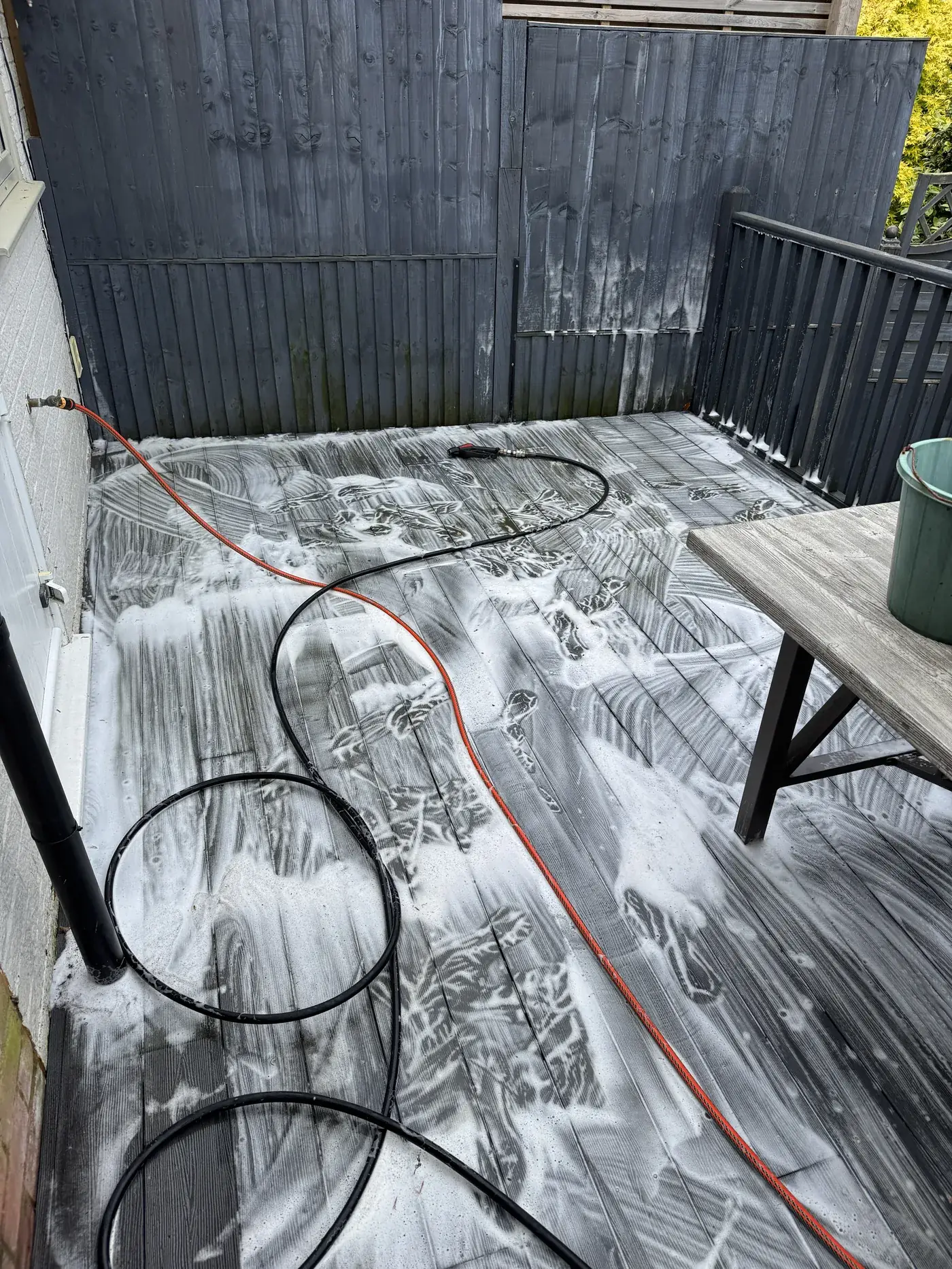 Composite decking before soft wash cleaning — algae and green growth