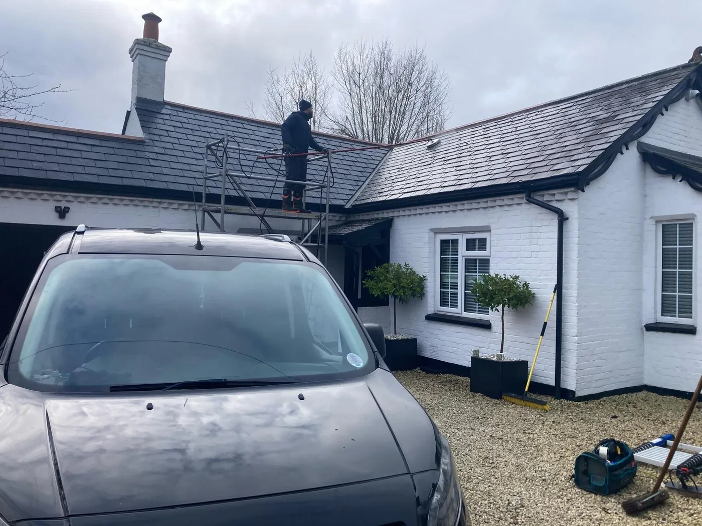 Jakub on scaffold tower carrying out professional roof moss removal in Berkshire — PowerJ Exterior Cleaning